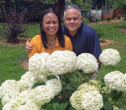 Bobby and Lynn at Bobby & Lynn's Plant Farm with white hydrangeas
