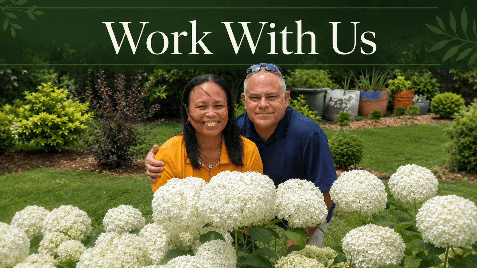 Smiling couple in a garden with large white hydrangeas in the foreground and a green header that says 'Work With Us'.