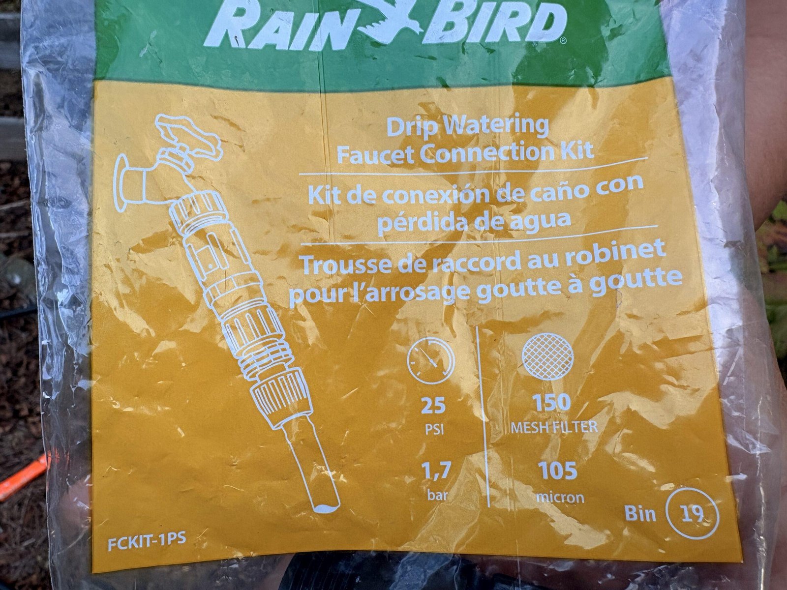 Rain Bird drip irrigation faucet connection kit with backflow preventer, pressure reducer, and connector for 1/2-inch drip tubing.